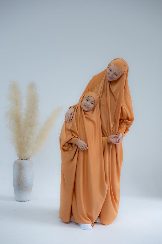 Little Gretaah prayer gown for kids in khimar style with ribbed sleeve cuff in Orange - ANNAH HARIRI