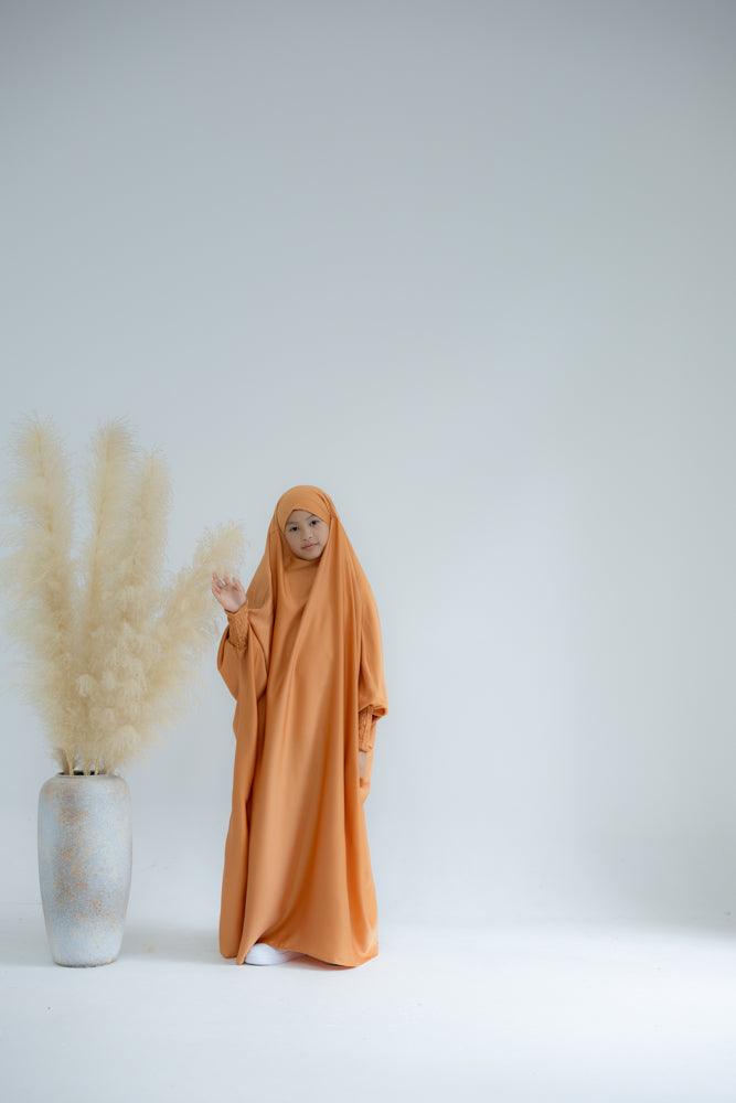 Little Gretaah prayer gown for kids in khimar style with ribbed sleeve cuff in Orange - ANNAH HARIRI