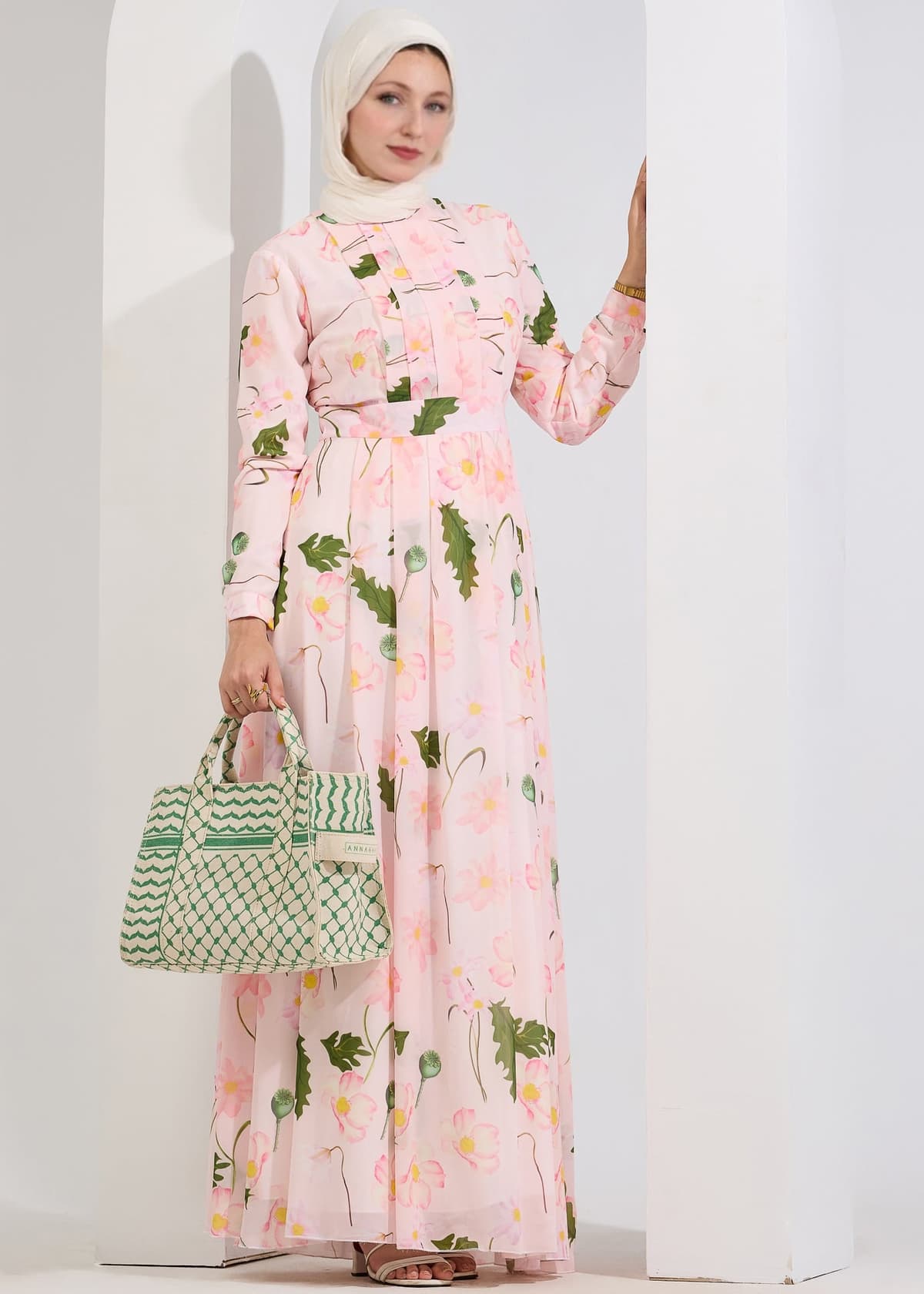 Closeup of model in blush floral chiffon maxi dress with high neck