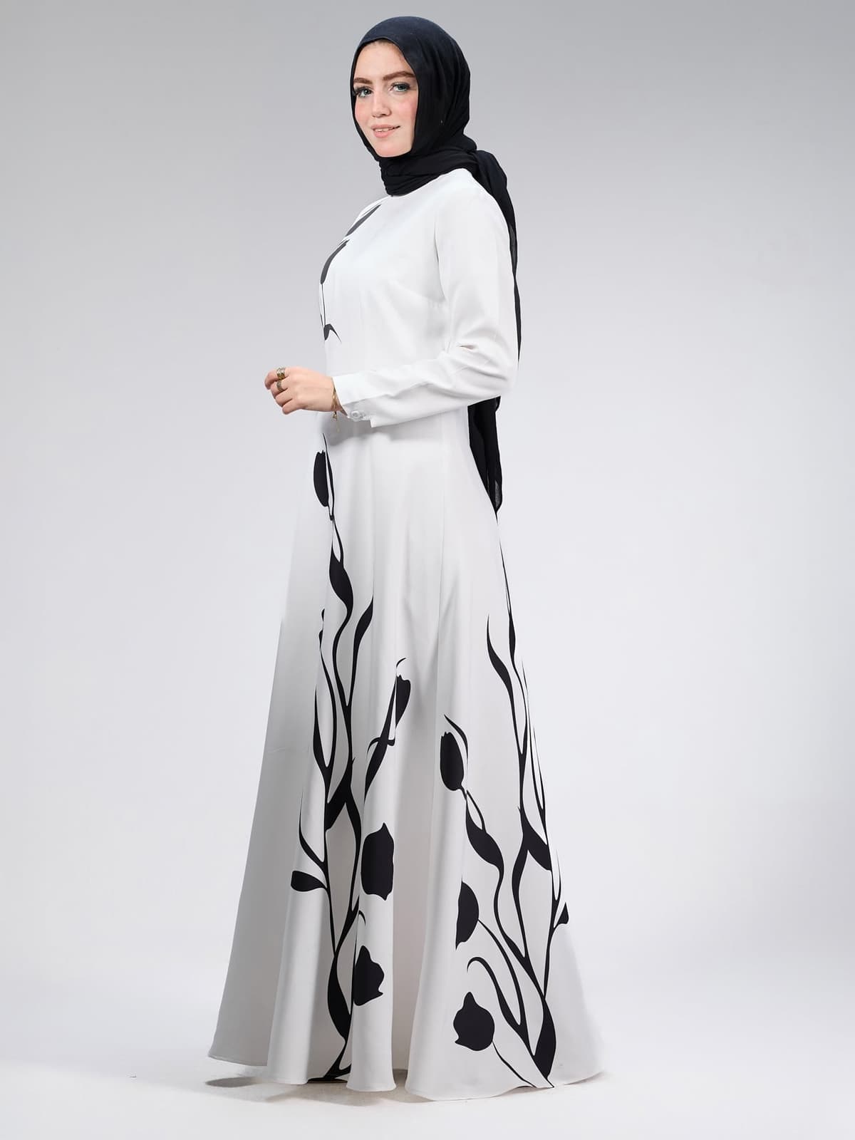 Close-up detail of black tulip floral design on maxi dress