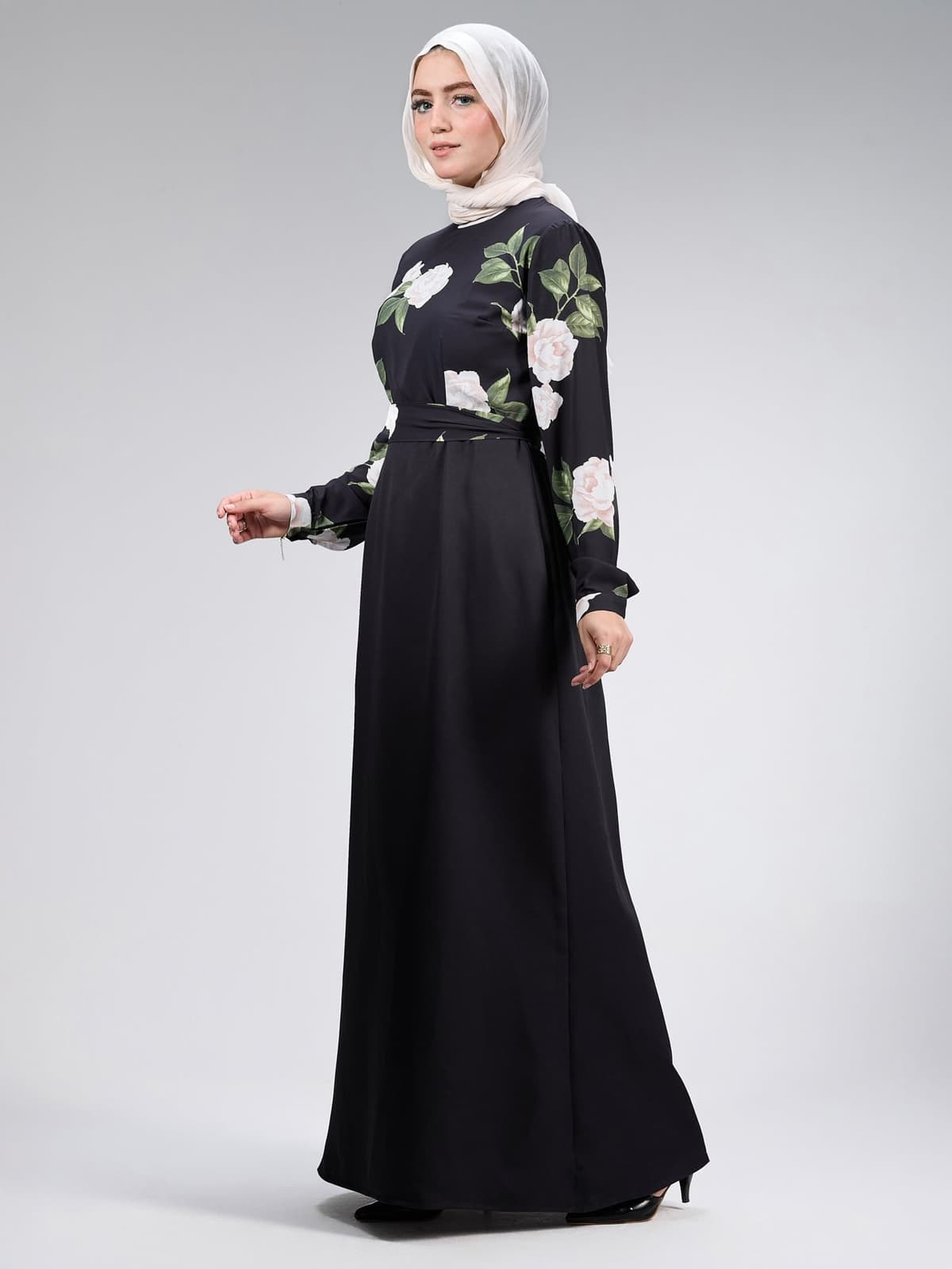Detailed view of floral design on black maxi dress