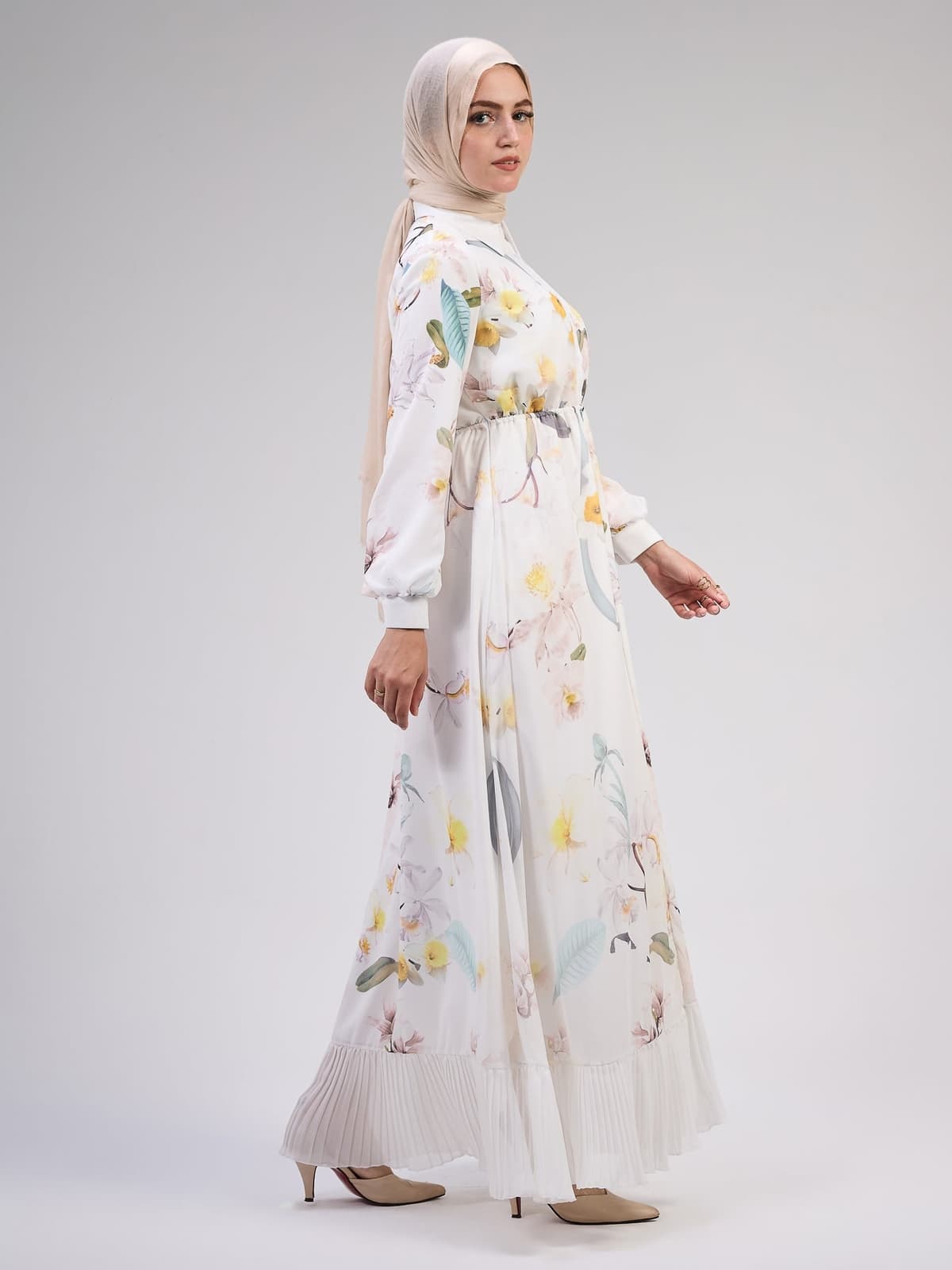 Close-up of the pleated hem on the ivory floral maxi dress