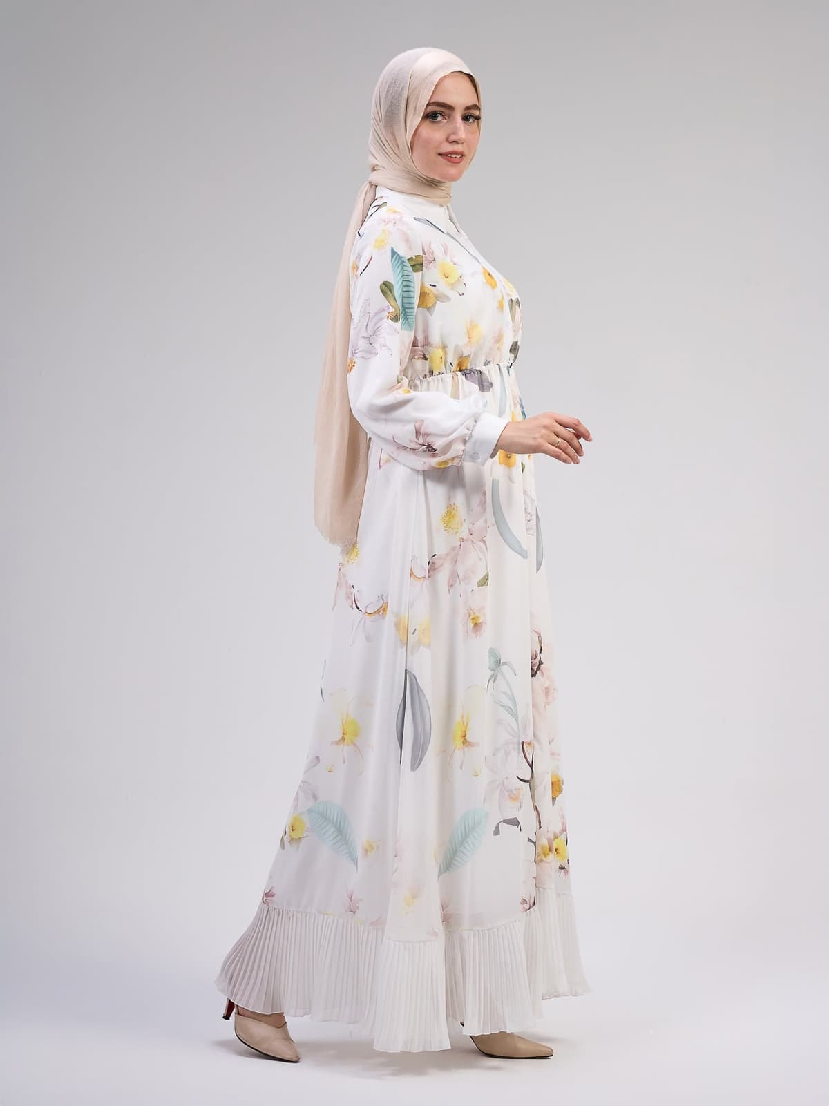 Close-up of floral patterns on the ivory chiffon dress