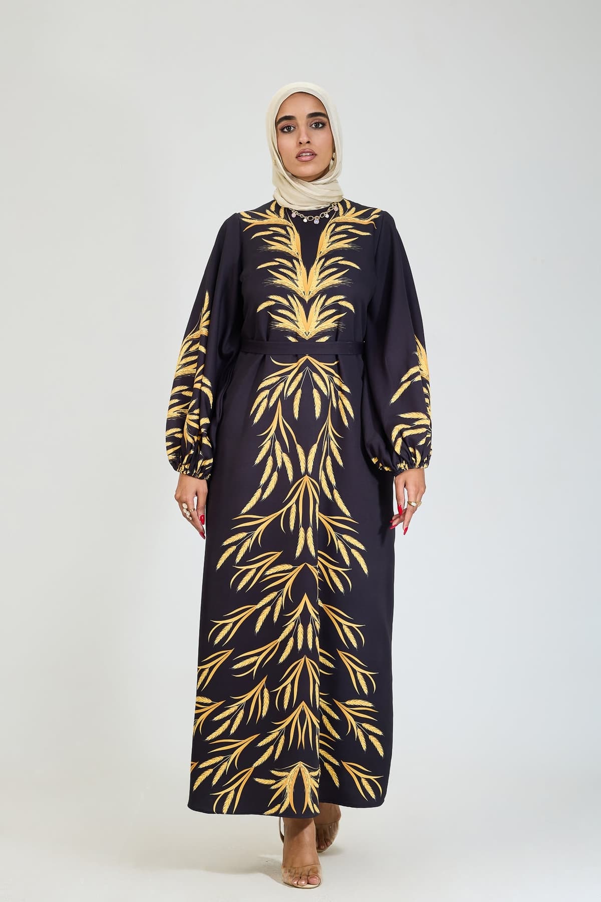 Close-up of bodice on black crepe dress with golden leaf motif.