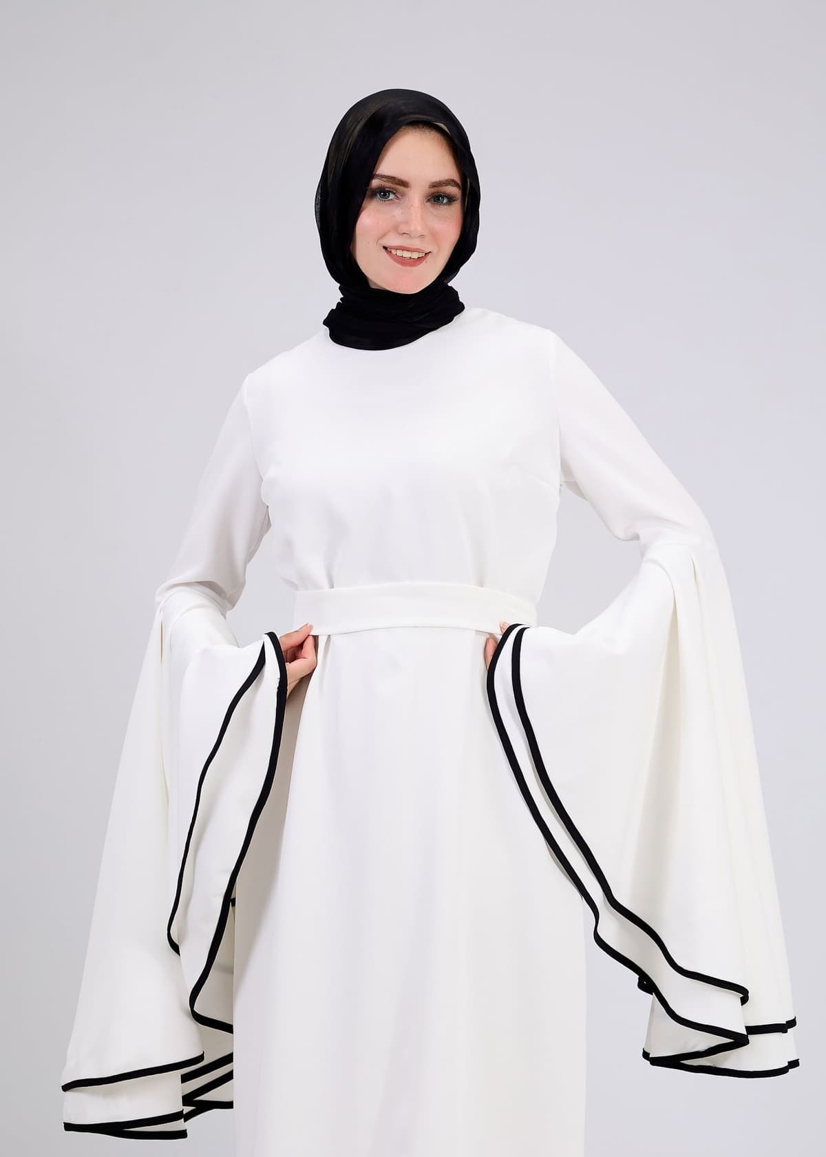 Side view of the white flared sleeve dress