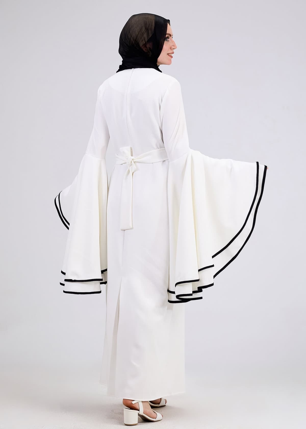 Model wearing white flared sleeve dress front view