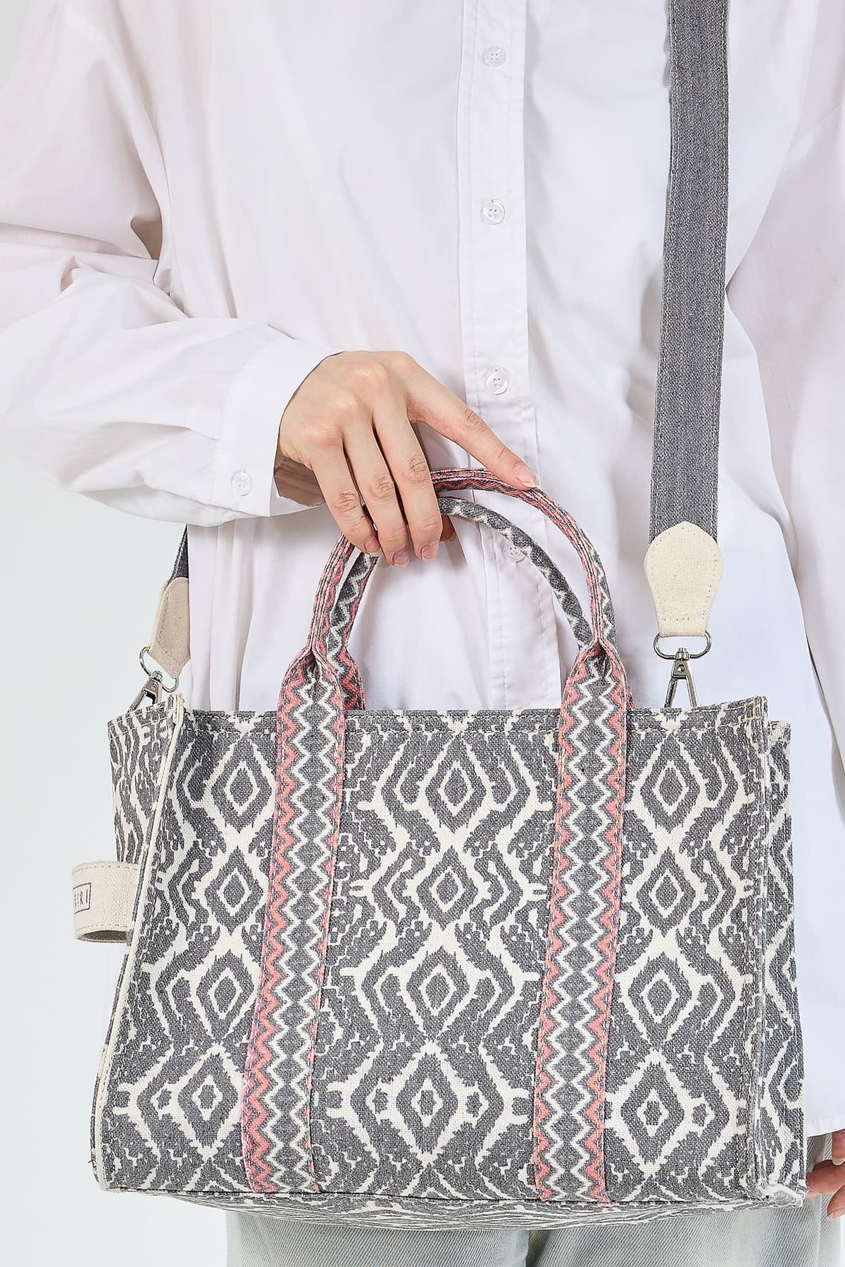 Side view of gray and coral Keffiyeh pattern tote