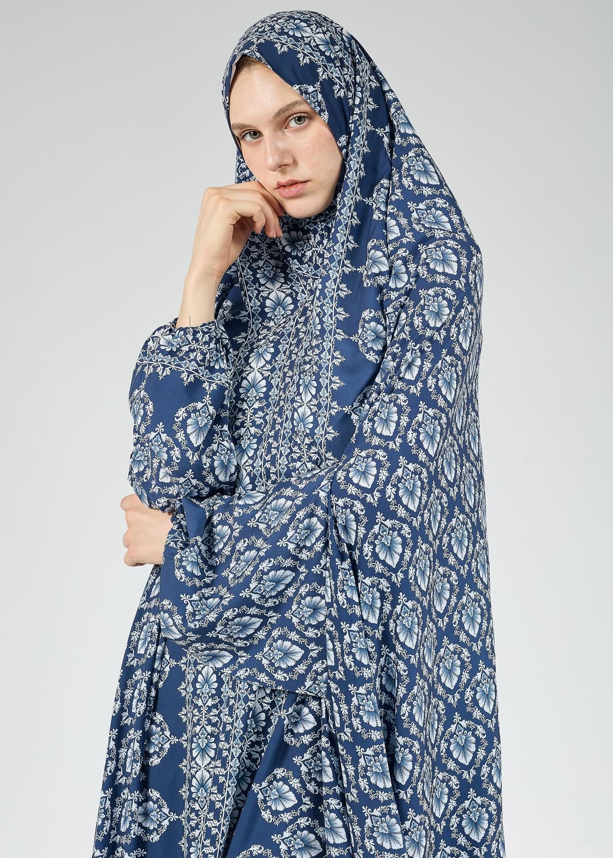 Close-up of intricate Gzhel print on satin prayer gown
