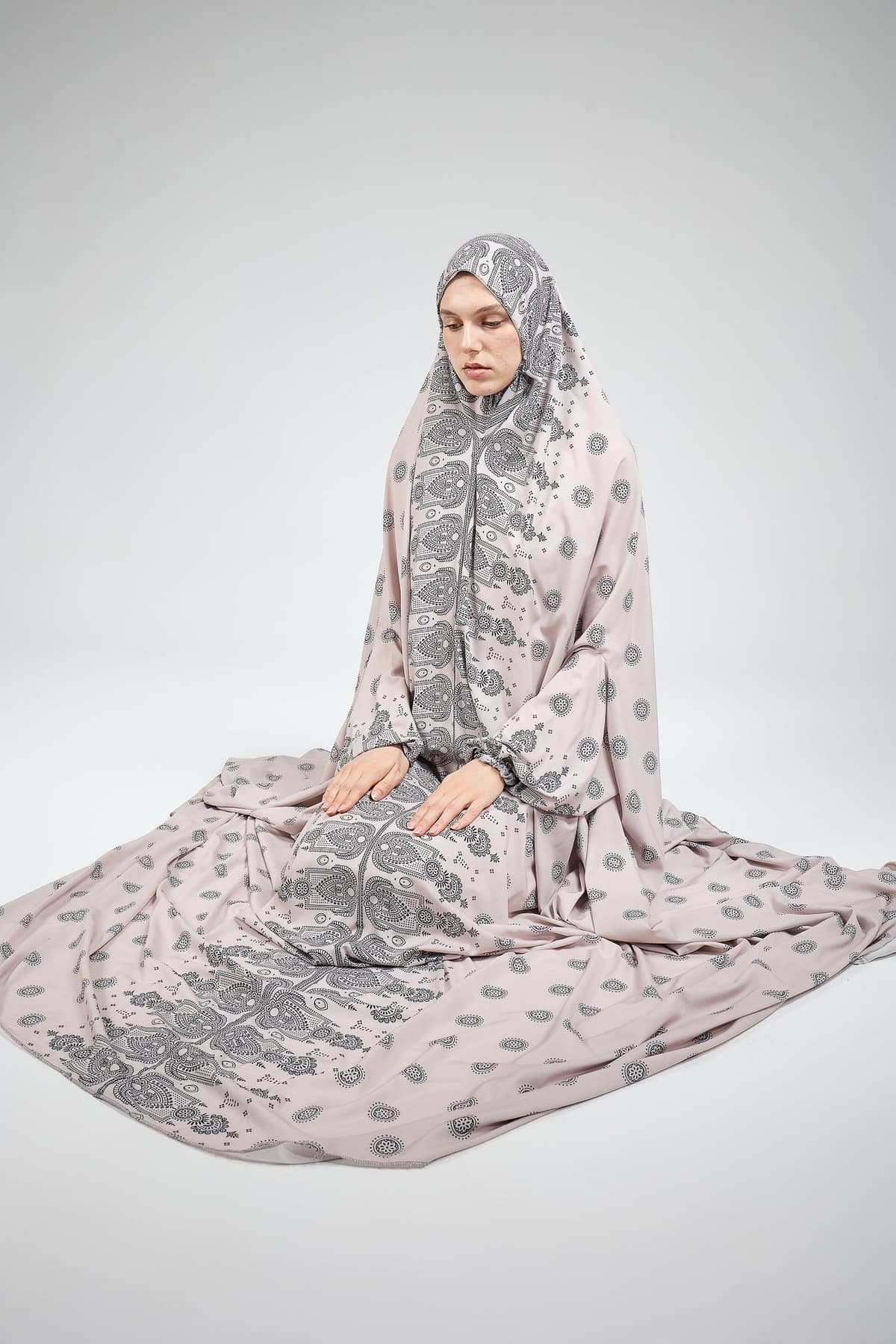 Detailed view of satin prayer gown’s paisley pattern