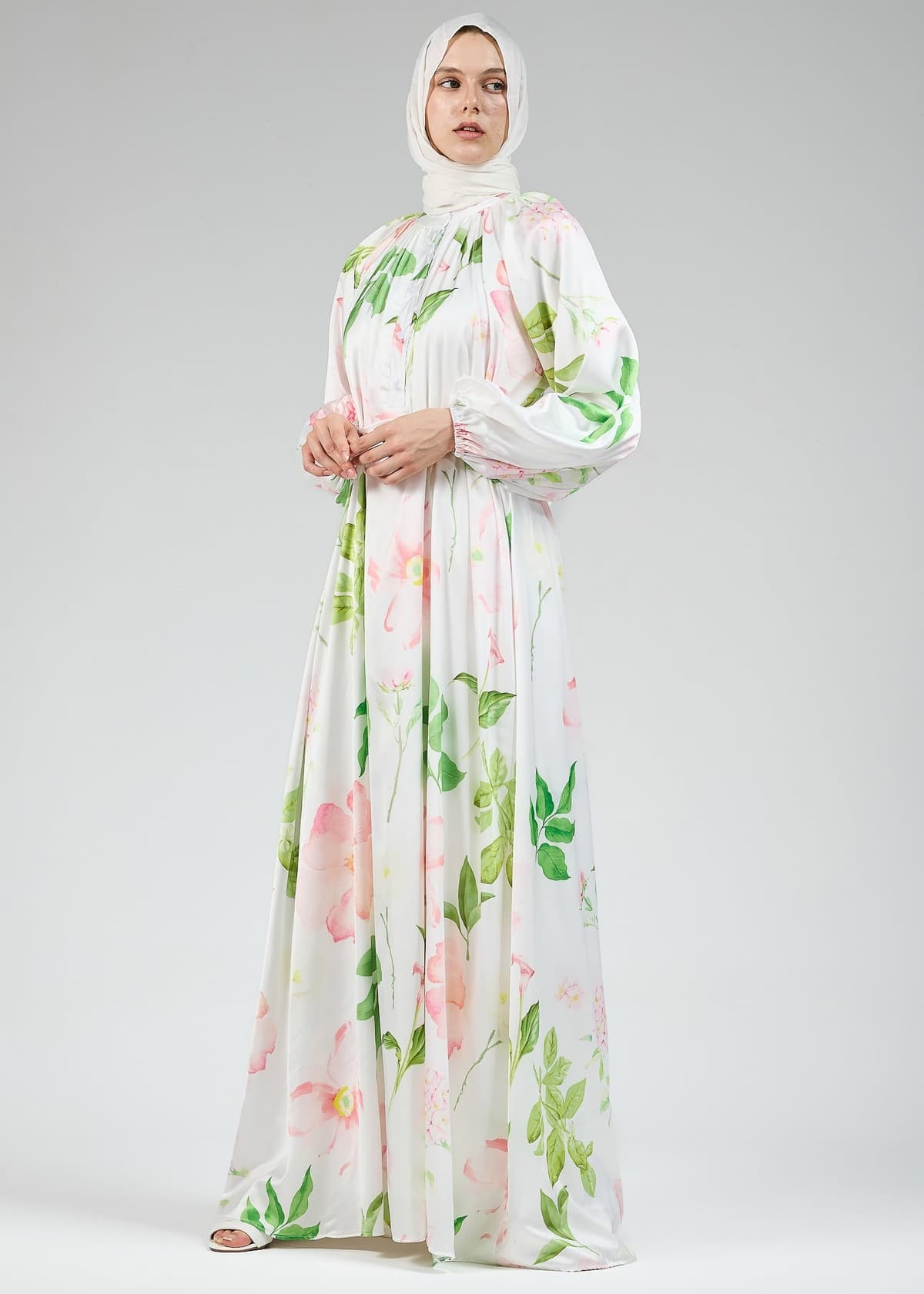 Detailed view of the floral design on the white satin dress