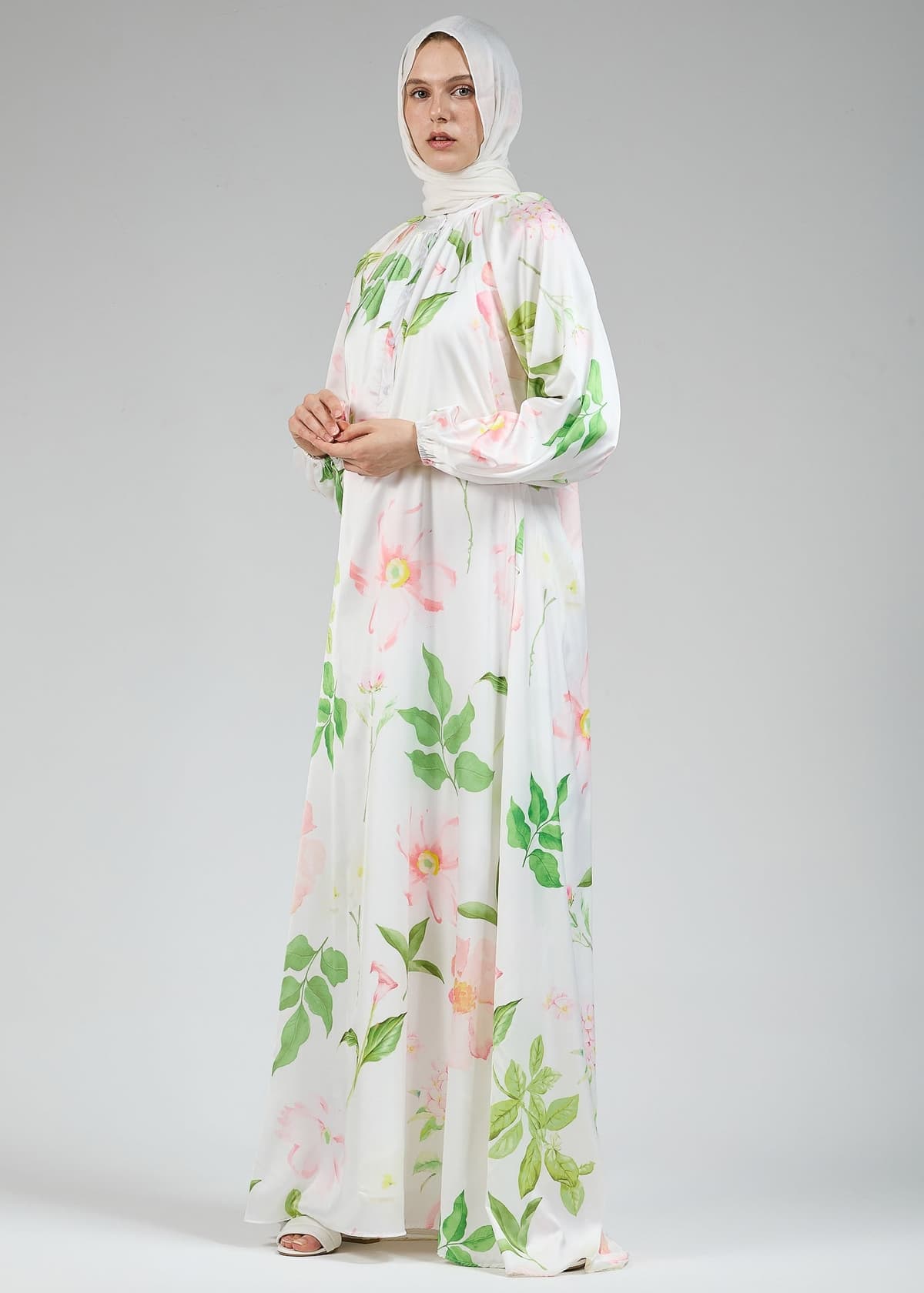 A front view of the long white satin dress with floral design