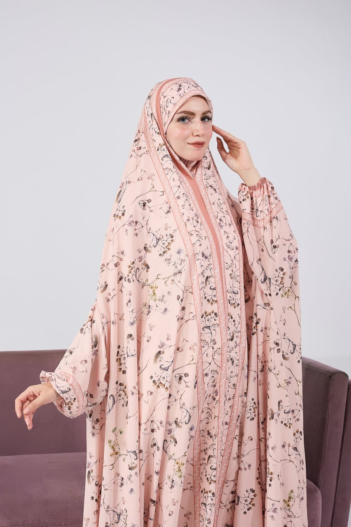 Seated full-length view of the satin floral prayer gown