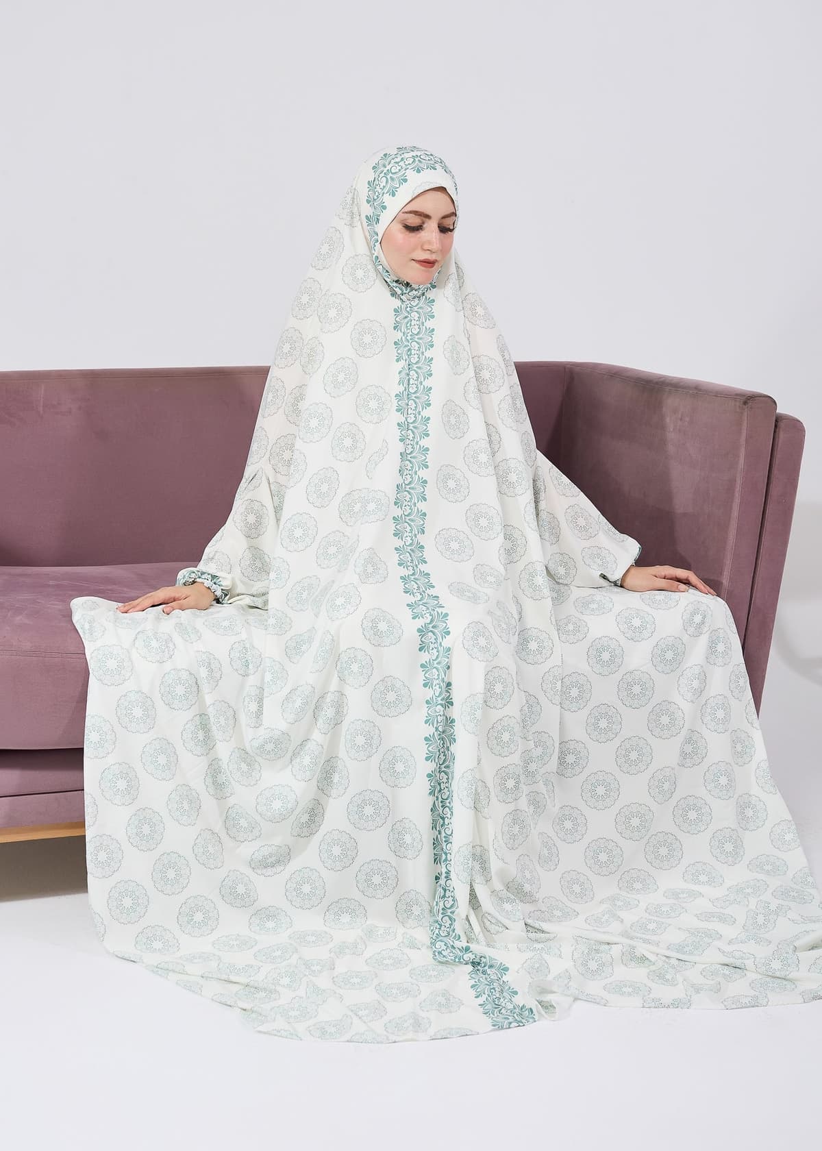Woman in prayer wearing a floral satin gown