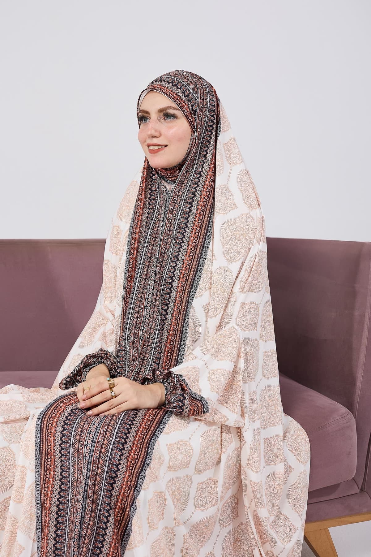 Model standing in satin gown dress with flowing bohemian patterns