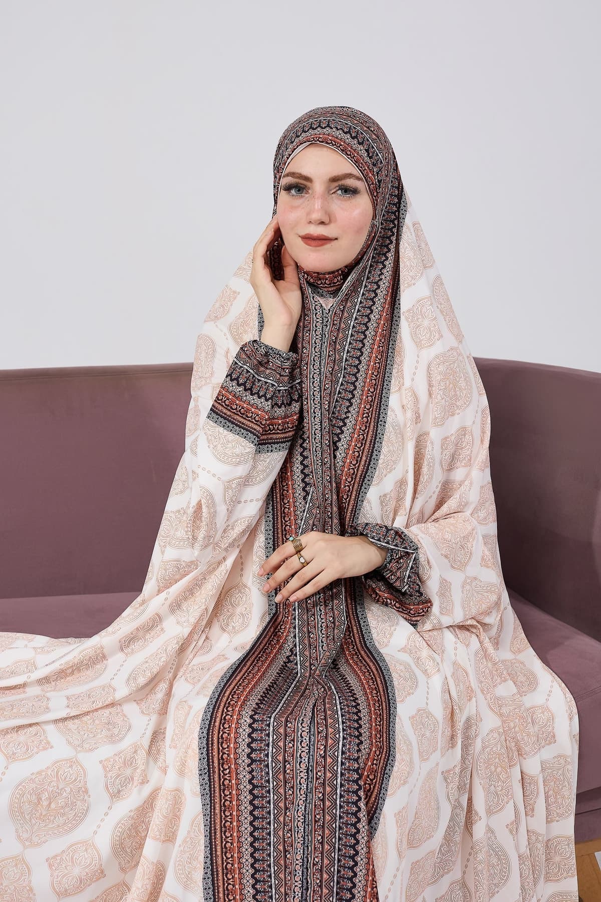 Close-up of satin gown dress with detailed bohemian print