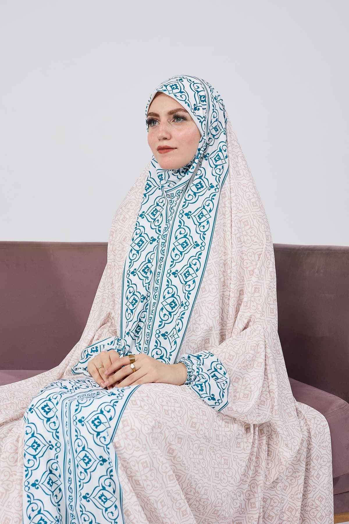 Woman seated in satin home prayer gown