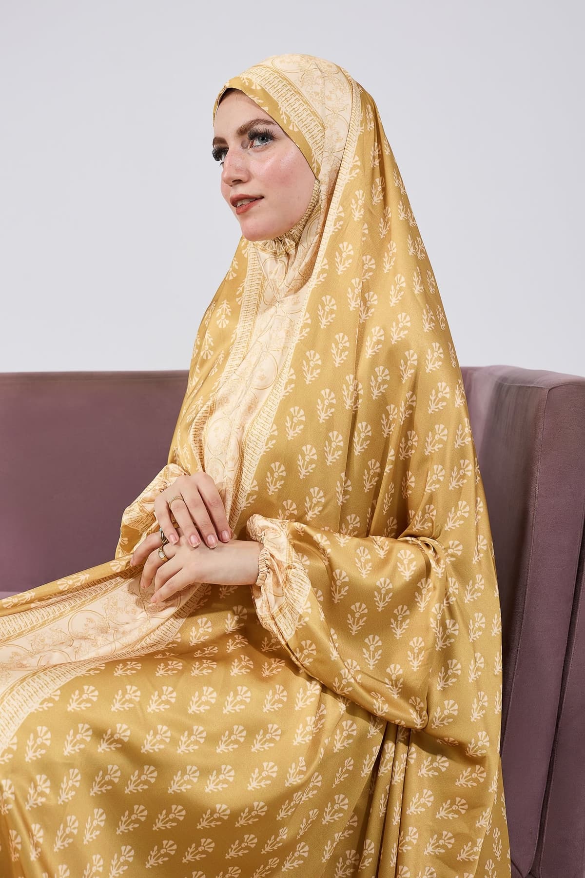 Full-length front view of the golden satin prayer gown
