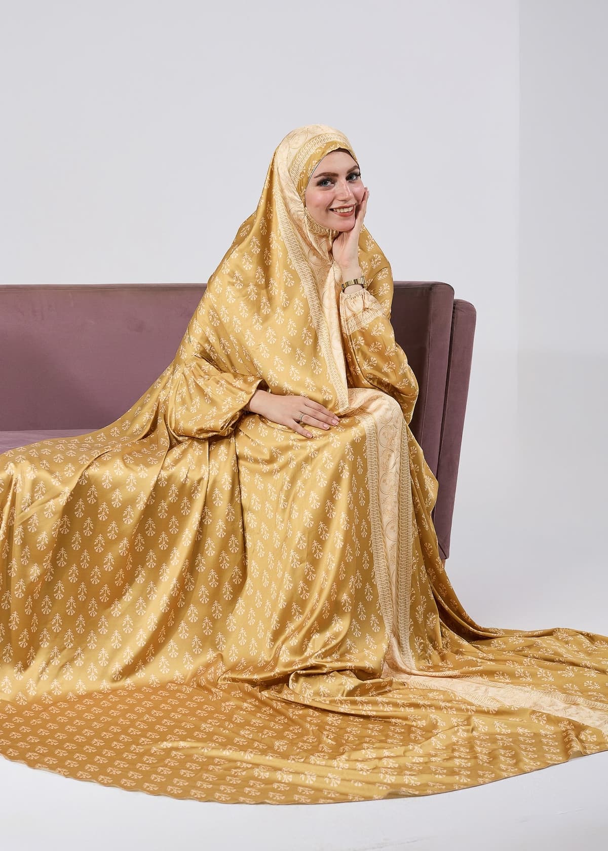 Golden satin prayer gown with detailed sleeve design