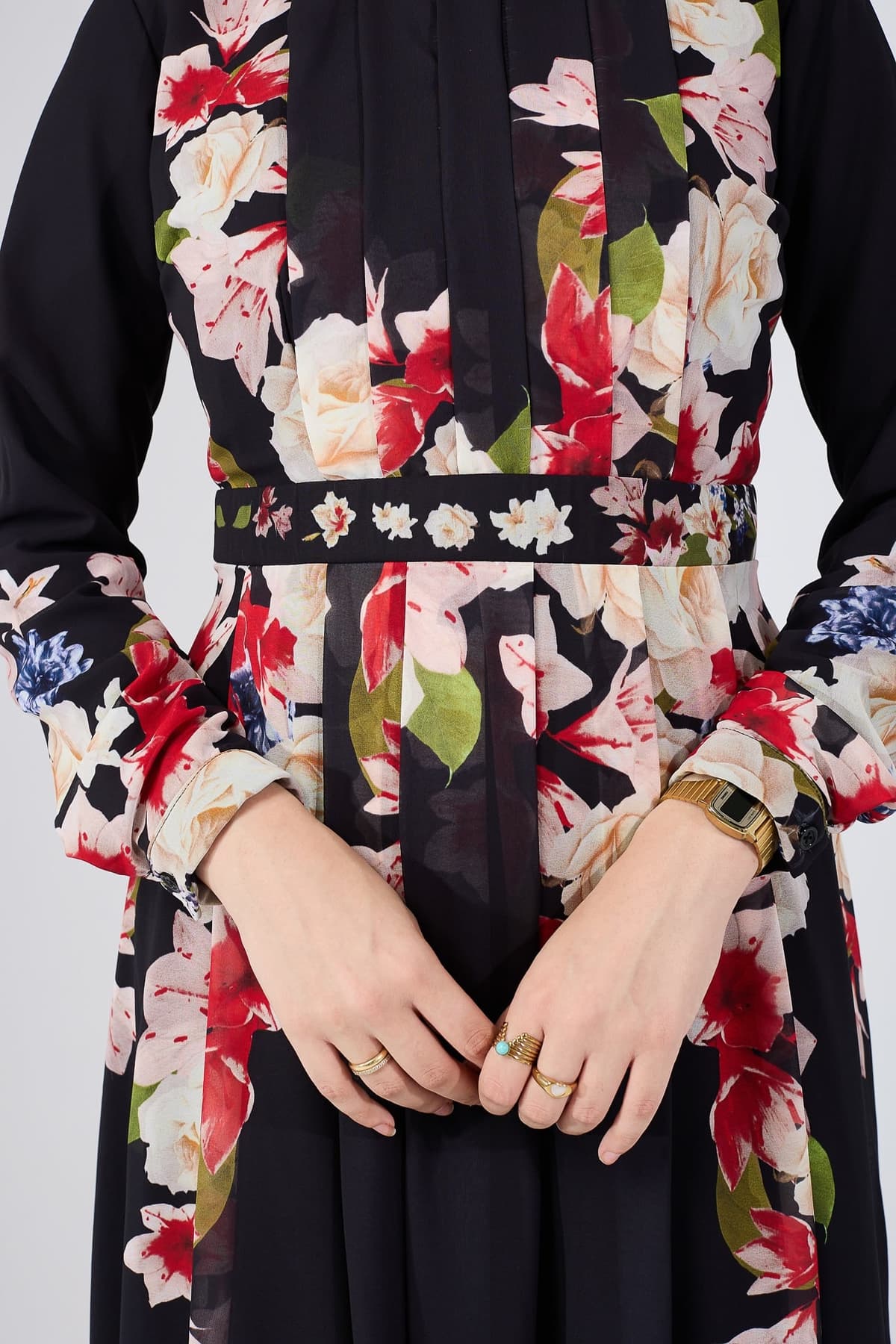 Detailed view of sleeve with floral accents on chiffon maxi dress