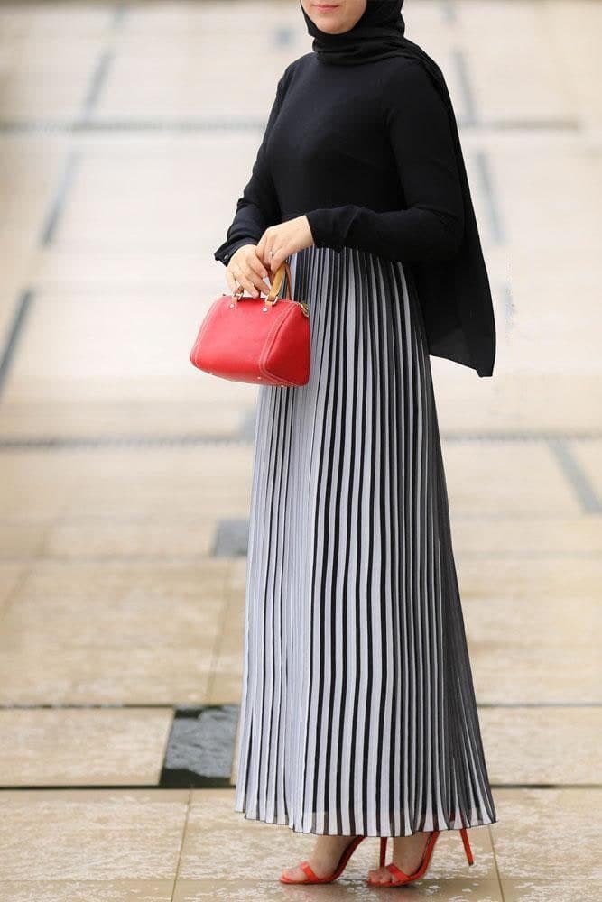 Elegant Accordion Pleats Maxi Dress paired with a red handbag