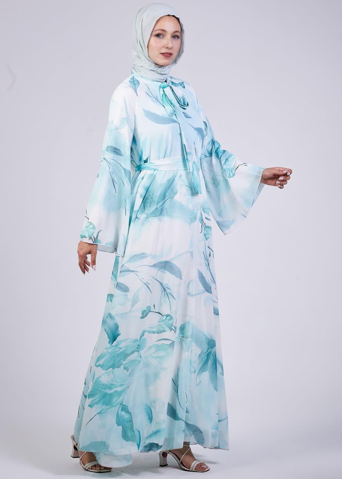 Side view of the Elegance Floral Maxi Dress showcasing flowing design and floral print