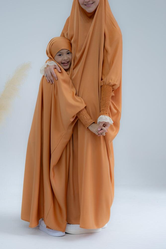 Little Gretaah prayer gown for kids in khimar style with ribbed sleeve cuff in Orange - ANNAH HARIRI
